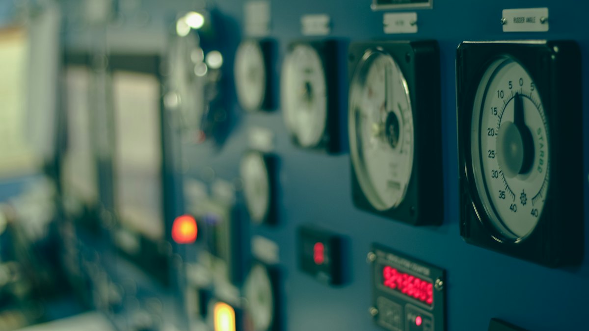 Gauges and indicator lamps on a building control panel.